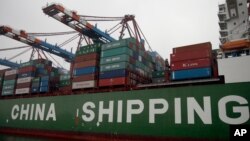 FILE - Containers are pictured on board the 'Star' vessel of the China Shipping Container Lines shipping company at the harbor in Hamburg, Germany.